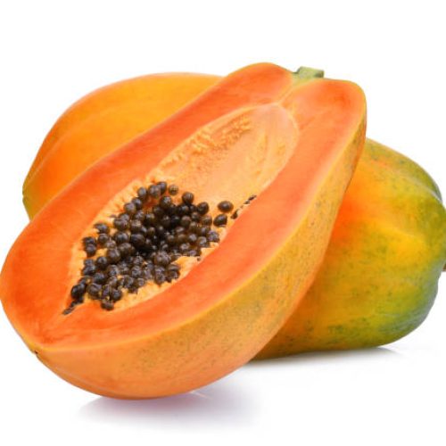whole and half of ripe papaya fruit with seeds isolated on white background
